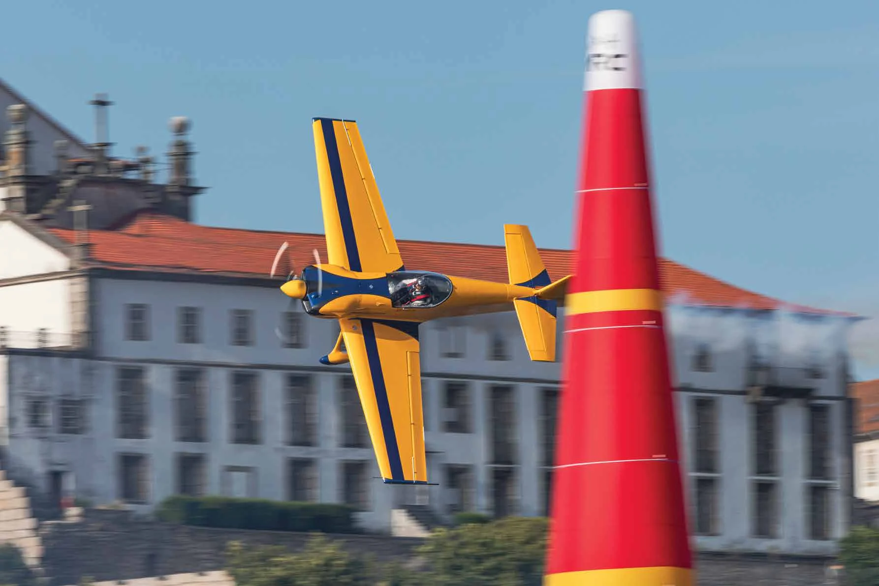 Edge 540 racing past an ARC pylon in front of Porto
